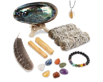May include: A smudging kit with a variety of items for cleansing and spiritual practices. The kit includes a white sage bundle, palo santo sticks, a feather, a seashell, a crystal necklace, a lava rock bracelet with chakra stones, and seven chakra stones.