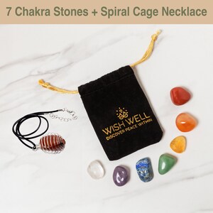 May include: A set of seven chakra stones in a velvet pouch with a spiral cage necklace. The stones are red, orange, yellow, green, blue, indigo, and violet. The pouch is black with gold embroidery that reads "Wish Well Discover Peace Within".
