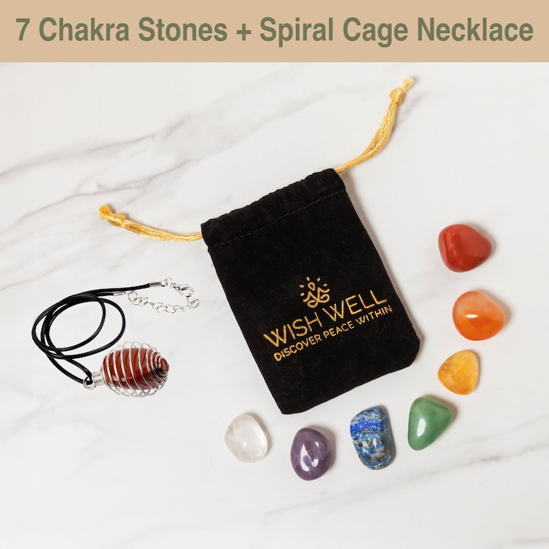 May include: A set of seven chakra stones in a velvet pouch with a spiral cage necklace. The stones are red, orange, yellow, green, blue, indigo, and violet. The pouch is black with gold embroidery that reads "Wish Well Discover Peace Within".
