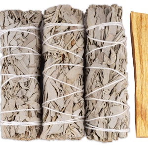 May include: Three white sage smudge sticks bundled with white twine, and one palo santo stick. The sticks are approximately 4 inches long.