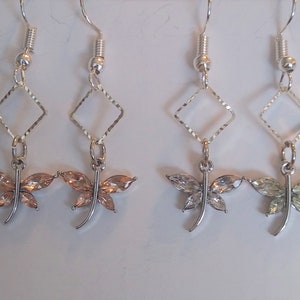 Delicate dangling dragonflies. Please choose pink or clear.
