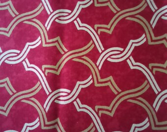 May include: Red fabric with a repeating pattern of white and gold interlocking curved lines. A measuring tape is at the bottom of the image with the numbers 2, 3, 4, 5, 6, 7, 8, and 9 visible. The text "MADE IN CHINA" is printed on the tape.
