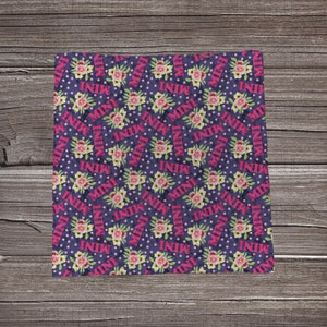 May include: A purple fabric with a repeating pattern of pink flowers, white dots, and the word "MINI" in pink letters.
