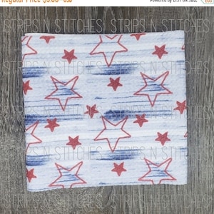 May include: White fabric with a blue and red star pattern. The stars are outlined in blue and filled in red. The fabric has a blue and white striped pattern.