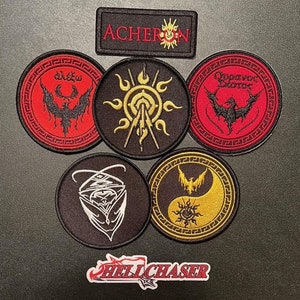 May include: Six embroidered patches with various designs, including a sun, a bird, and a yin-yang symbol. The patches are all black and red with gold accents. The text "ACHERON" is visible on one of the patches. The text "HELLCHASER" is visible on a separate patch.