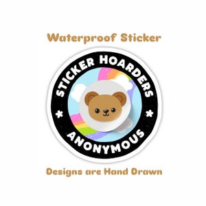 May include: A round, waterproof sticker with a cartoon bear in the center, surrounded by a black border with the words "STICKER HOARDERS ANONYMOUS". The background features a rainbow and clouds. The text "Waterproof Sticker" and "Designs are Hand Drawn" are also included.