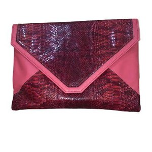 May include: A pink and burgundy clutch with a snakeskin pattern. The clutch has a flap closure with a pink trim. The body of the clutch is a mix of pink and burgundy colors.