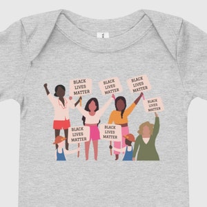 May include: A gray baby onesie with a graphic of a group of people holding signs that say "Black Lives Matter".