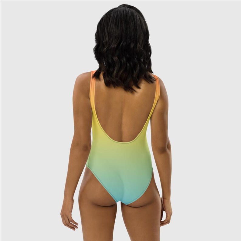 May include: A one-piece swimsuit with a gradient design, transitioning from orange to yellow to green to blue.
