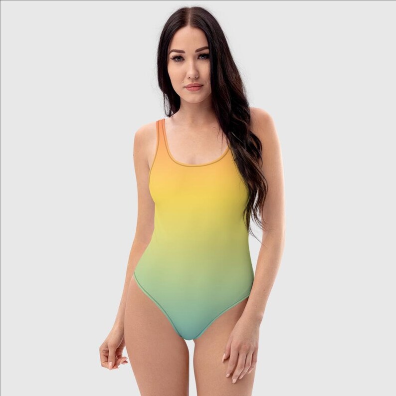 May include: A one-piece swimsuit with a gradient design, transitioning from orange to yellow to green and blue.