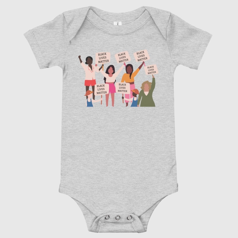 May include: A gray baby onesie with a graphic of a group of people holding signs that say "Black Lives Matter".