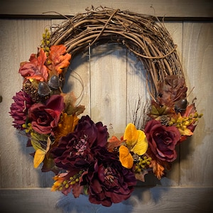Fall Grapevine wreath.  Quality silk florals in deep burgundy, leaves in rich golds, browns and rusty orange, and accented with acorns.