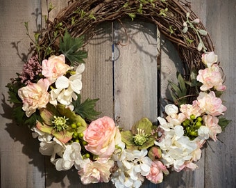 Spring 18” Grapevine Wreath, with quality cream and coral colored silk florals and foliage.  Perfect decor for any Wall or Door.