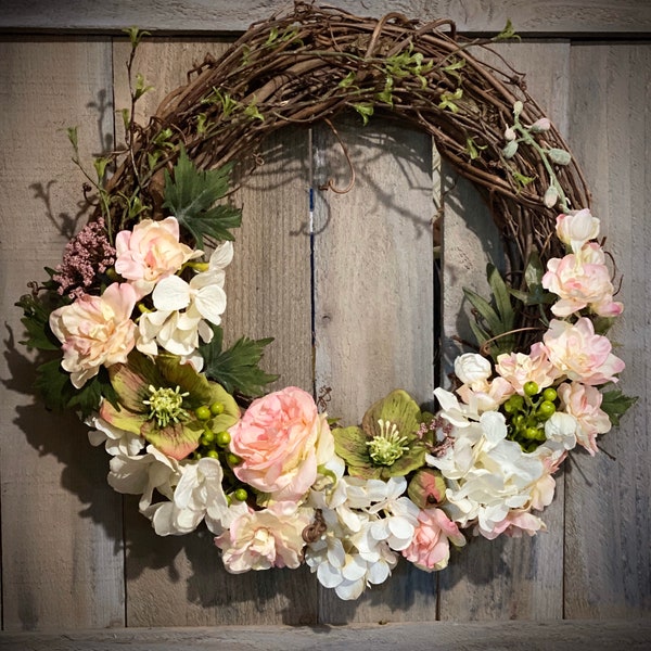 Spring 18” Grapevine Wreath, with quality cream and coral colored silk florals and foliage.  Perfect decor for any Wall or Door.