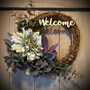 This small 8” wreath is the perfect touch to welcome guests.  Pale blue & lavender dahlia and hydrangea, purple sage, and eucalyptus.