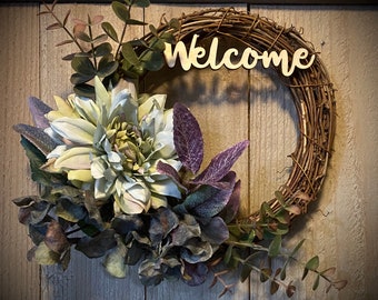 This small 8” wreath is the perfect touch to welcome guests.  Pale blue & lavender dahlia and hydrangea, purple sage, and eucalyptus.