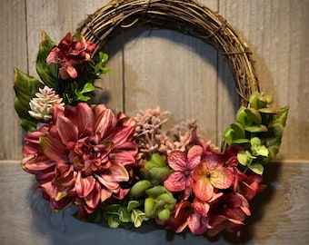 This small 8” wreath is the perfect touch for spring or summer.  Dusty rose dahlia and hydrangea, berries, and succulent accents.