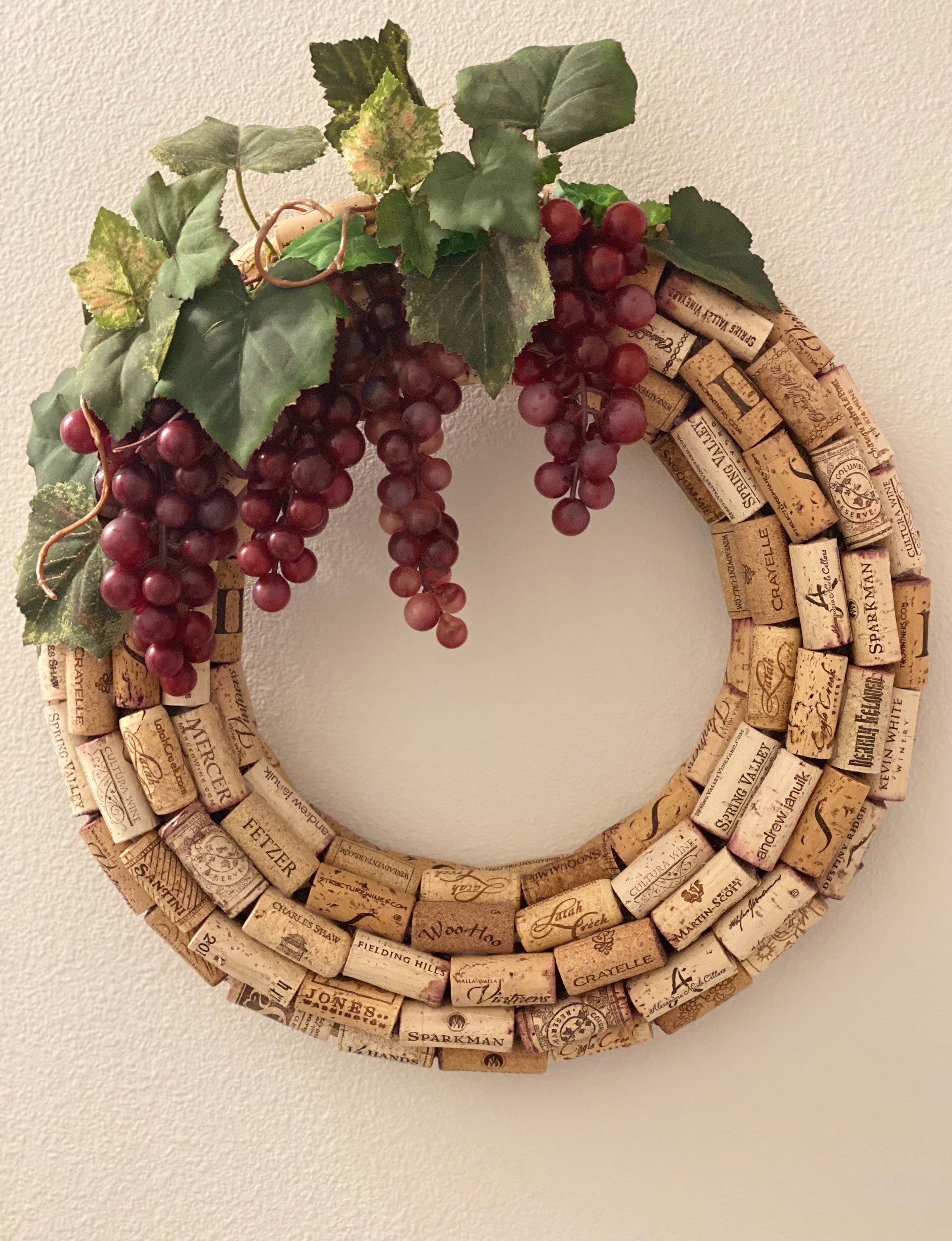 Wine Cork Wreath with Grape varieties, 16” diameter, attached metal D-ring hanger.