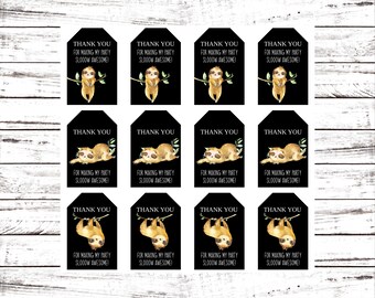 May include: Twelve black and white thank you tags with a sloth illustration and the text "Thank you for making my party slooow awesome!"