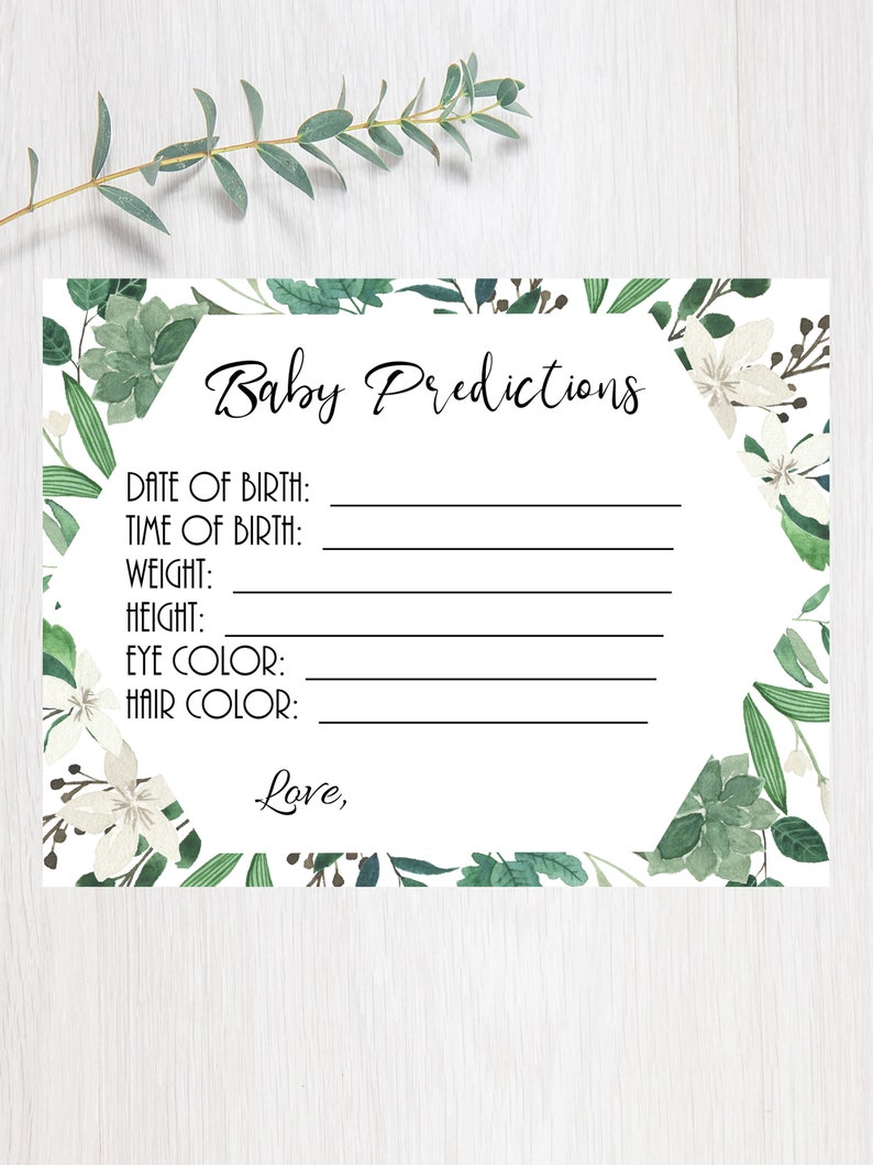 May include: A white card with a green floral border and the text "Baby Predictions". The card has blank lines for guests to write down their predictions for the baby's birth date, time, weight, height, eye color, and hair color.