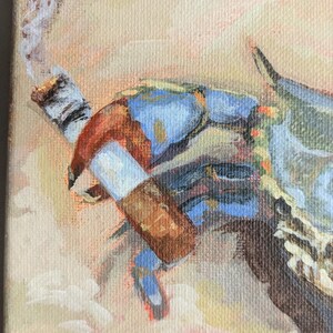 May include: An acrylic painting of a blue crab smoking a cigarette. The crab is painted with blue, brown, and orange hues, with a lit cigarette in its claw. The background is a soft blend of peach and cream colors.