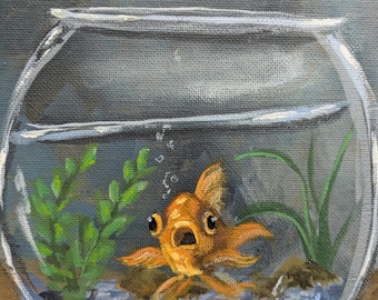 May include: An orange goldfish with wide eyes and an open mouth swims in a clear glass bowl. The bowl contains water, green plants, and small blue pebbles. The background is a muted gray.