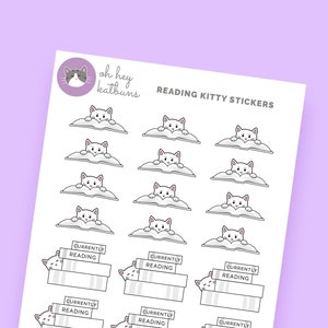 May include: A sheet of stickers featuring white cats reading books. The stickers are designed for use in planners and journals. The text on the stickers reads "Currently Reading".