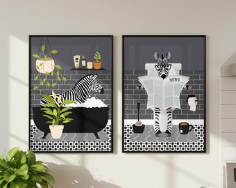 May include: Two framed wall art prints featuring a zebra in a bathroom setting. The left print shows a zebra in a black bathtub with bubbles and plants. The right print shows a zebra wearing glasses on a toilet reading a newspaper labeled NEWS.
