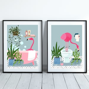 Set of Two Flamingo Bathroom Prints. One flamingo on the bath and one flamingo in the bidet. Light Blue Print.