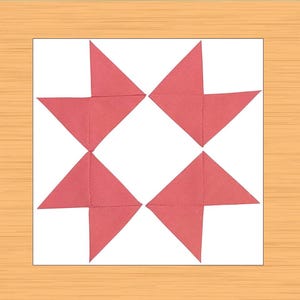 Puede incluir: Una manualidad de papel cuadrada con un diseño en forma de estrella. El diseño está compuesto por seis formas de papel rojo doblado dispuestas sobre un fondo blanco. La obra de arte está sobre una superficie de madera marrón claro.