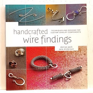 May include: A square instructional book titled Handcrafted Wire Findings: Techniques and Designs for Custom Jewelry Components by Denise Peck and Jane Dickerson. The cover features various metal wire jewelry components against colorful backgrounds.