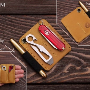 May include: A tan leather wallet with multiple pockets for carrying a pen, a multi-tool, and a small pocket knife. The wallet is labeled "MINI" and has a pen slip that is optional.