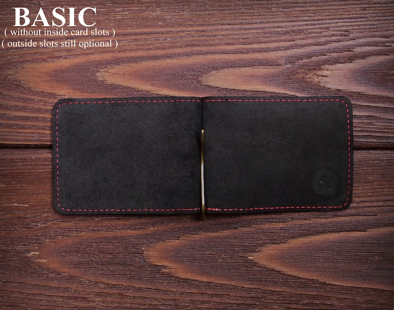 May include: A black leather wallet with red stitching detail and a metal money clip. The wallet is open and the inside is empty. The text "BASIC (without inside card slots) (outside slots still optional)" is above the wallet.