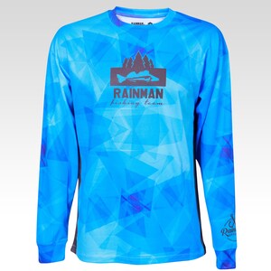 May include: A blue long-sleeved shirt with a geometric pattern. The shirt has a black logo with the text "Rainman fishing team" and a silhouette of a fish and trees.
