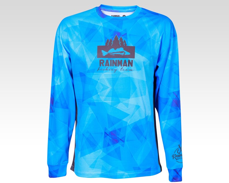 May include: A blue long-sleeved shirt with a geometric pattern. The shirt has a black logo with the text "Rainman fishing team" and a silhouette of a fish and trees.