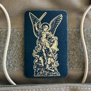 May include: A set of three ceramic mugs with a speckled, cream-colored glaze. Each mug features a different hand-painted floral design in shades of blue, green, and yellow. The mugs have a simple, rounded shape and a comfortable handle.