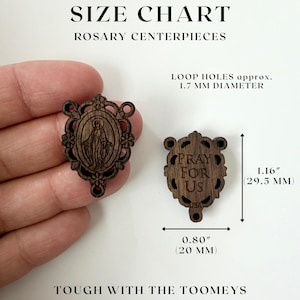 May include: Wooden rosary centerpieces with intricate designs. One features an image of a religious figure, the other reads "PRAY FOR US" with "USA" below. Dimensions are 1.16 inches (29.5 mm) high and 0.80 inches (20 mm) wide.