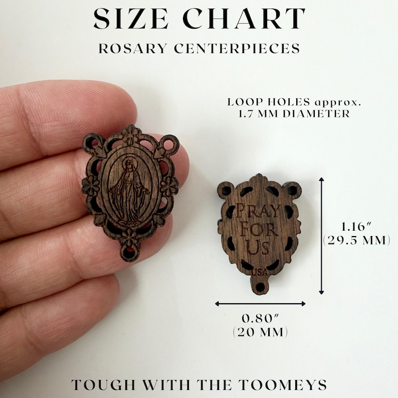 May include: Wooden rosary centerpieces with intricate designs. One features an image of a religious figure, the other reads "PRAY FOR US" with "USA" below. Dimensions are 1.16 inches (29.5 mm) high and 0.80 inches (20 mm) wide.