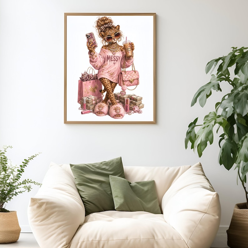 May include: A framed wall art print featuring a leopard character with a messy bun, wearing pink sunglasses, a pink sweatshirt with the word MESSY, and pink fuzzy slippers. The character holds a phone and a drink, surrounded by pink shopping bags and cash.