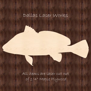 May include: Laser cut wooden cutout of a fish, made from 1/4 inch maple plywood. The cutout is on a brown wood background. The text "Dallas Laser Works" is at the top of the image and the text "All items are laser cut out of 1/4" Maple Plywood" is at the bottom of the image.
