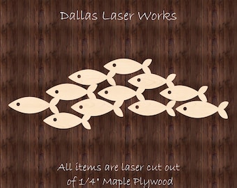 May include: A school of fish cut from 1/4 inch maple plywood. The fish are arranged in a layered formation, with the largest fish at the top and the smallest fish at the bottom.  All items are laser cut out of 1/4" Maple Plywood. Dallas Laser Works.