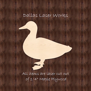 May include: A laser cut wooden duck silhouette, made from 1/4 inch maple plywood. The duck is facing left and has a simple design. The text "Dallas Laser Works" and "All items are laser cut out of 1/4" Maple Plywood" is visible below the duck.