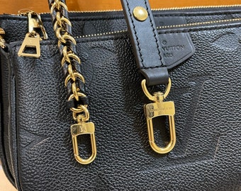 Protezione hardware per chiusura tracolla borsa Louis Vuitton