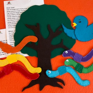 May include: A felt play set with a green tree, a blue bird, and six colorful worms. The set includes a poem about counting worms.