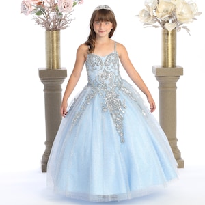 Baby blue glitter dress with silver sequins for pageants and special events .