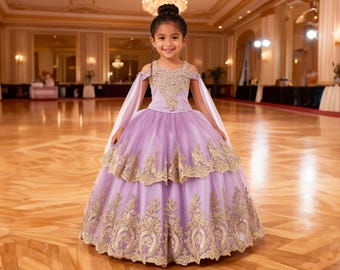 May include: A young girl in a lavender ball gown with gold embroidery. The dress features off-the-shoulder sleeves and a layered skirt. The background is a ballroom with a wooden floor.