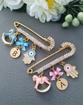 Personalized Gold Baby Stroller Pin with Hamsa Evil Eye for Good Luck and Protection product logo