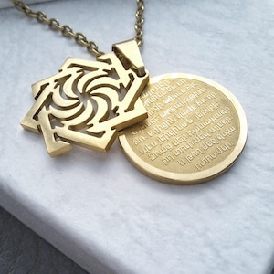 May include: Gold necklace with a pendant featuring a geometric design and a round disc with Armenian text. The text reads: "այրներ րկինս ես un լիցի անուն Քո։ Նեսցէ արքայութիւն ո։ Եղիցին կամք Քի որ պէս յերկինս և յերկրի։ Զհաց մեր հանապազո րդ տուր մեզ այսօր: և թող մեզ զպ արտիս մեր,"