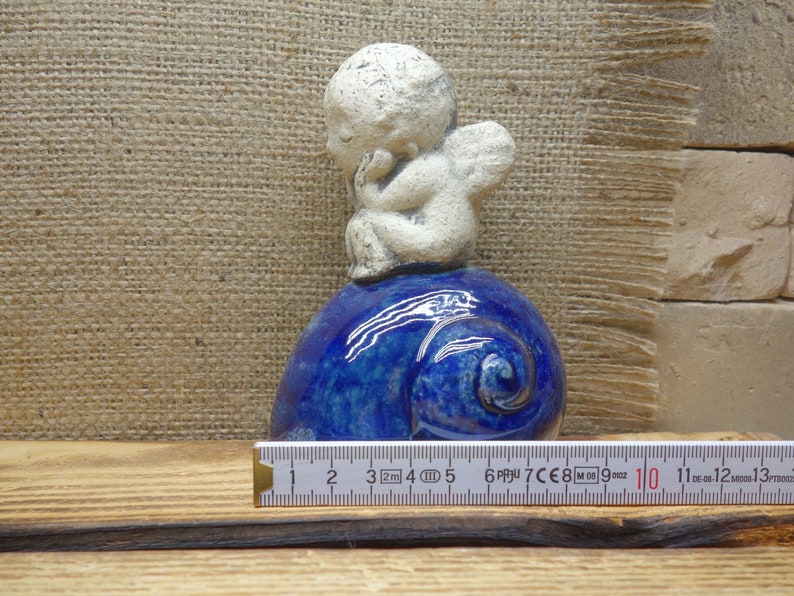 Ceramic figurine angel on a shell christmas angel