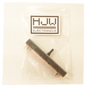 May include: A linear potentiometer component, packaged in a clear plastic bag. The component is gray and brown with a black control knob. The bag has a white label with the text "HJW ELECTRONICS". The background is a grid pattern.